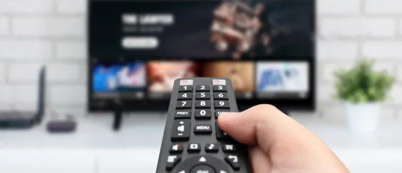 Man with remote control in hand